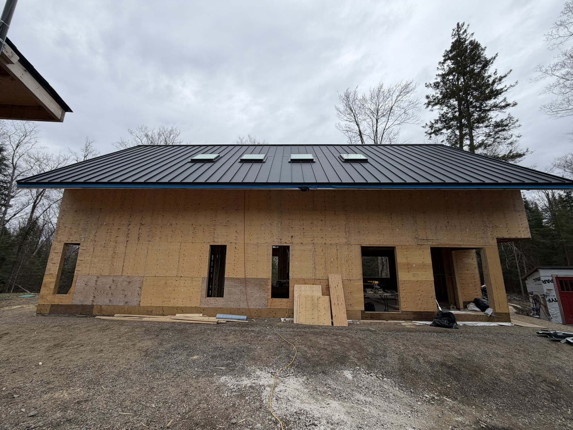 New construction matte black standing seam with skylights — VAH Construction